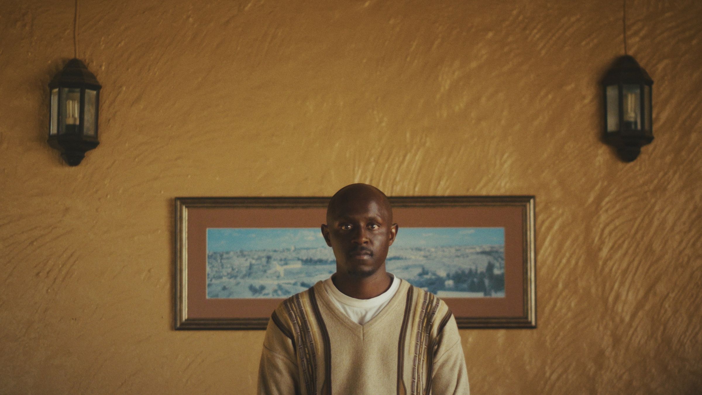 Jabulile Majola standing in front of a framed landscape painting